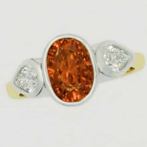 Gold ring with orange gemstone centerpiece
